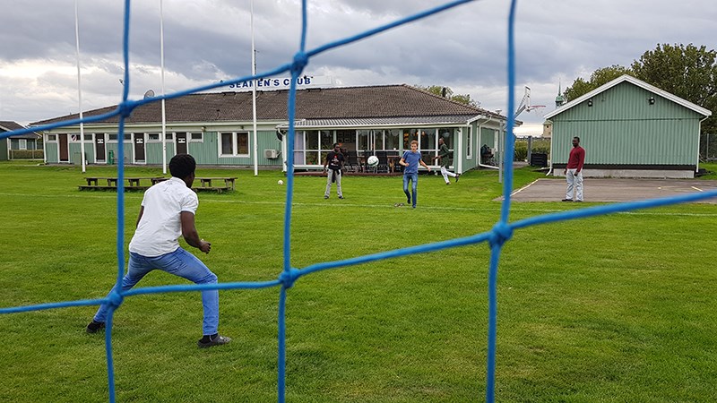 Five seafarers playing football on the backside of Johannisbor´s Seamen`s Club.