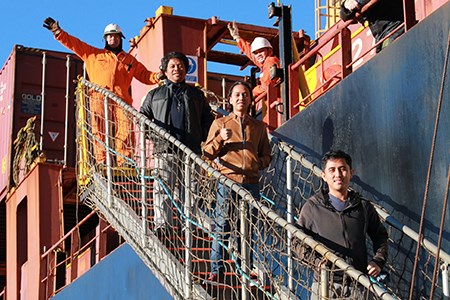 A group of seafarers leaving the ship from the gangway.