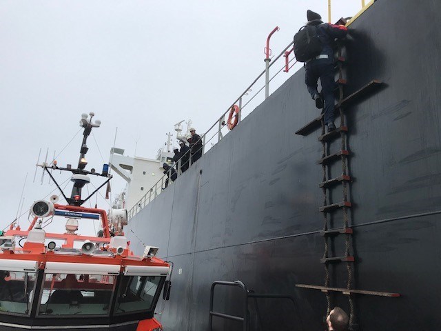 Pilot climbing on ladder