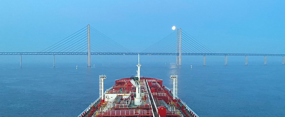 The bow of a vessel and a bridge up ahead.