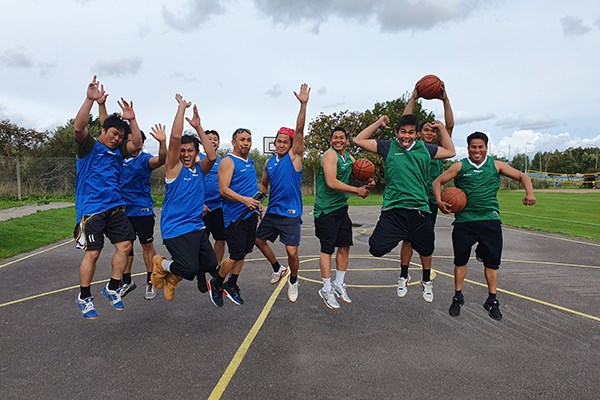 A group of seafarers jumping togheter on the basketball court at Johannisborg