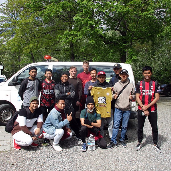 A group of seafarers in front of the minibus after the transport