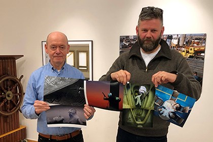 Arngrimur Blöndal and Kjartan "Golli" Thorbjörnsson showing the winning photos. The jury showing the winning photos