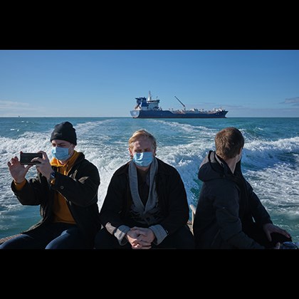 Swedish 1st place - ”Signing off year” 2020, Jörgen Språng, SE Three men with breathing masks, leaving their ship at sea, in an open boat