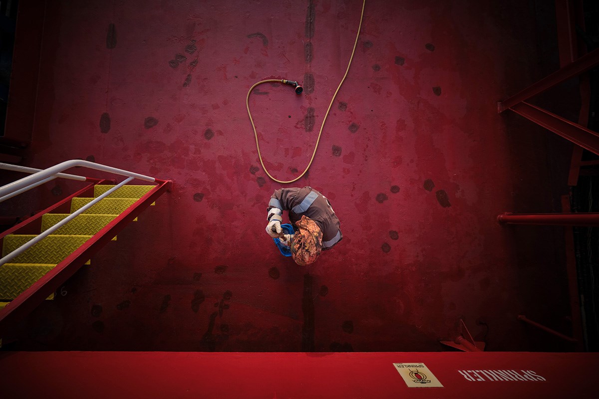 Birds-eye-view of a person swabbing the red deck
