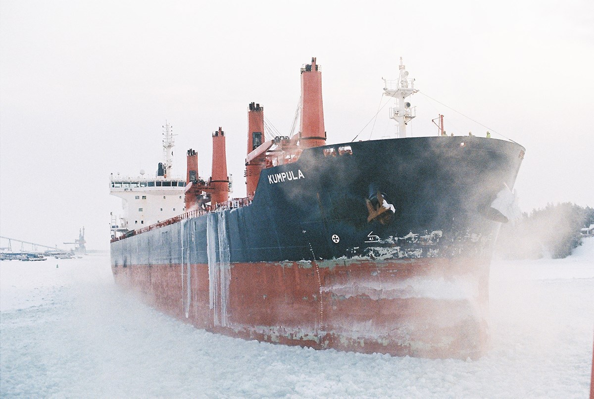A frosty ship in the fog appears to be stuck in the ice